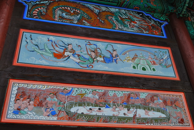 Horizontal rectangular paintings adorning the sides of the Beopjusa Buddhist Temple Complex showing deities and dragons.