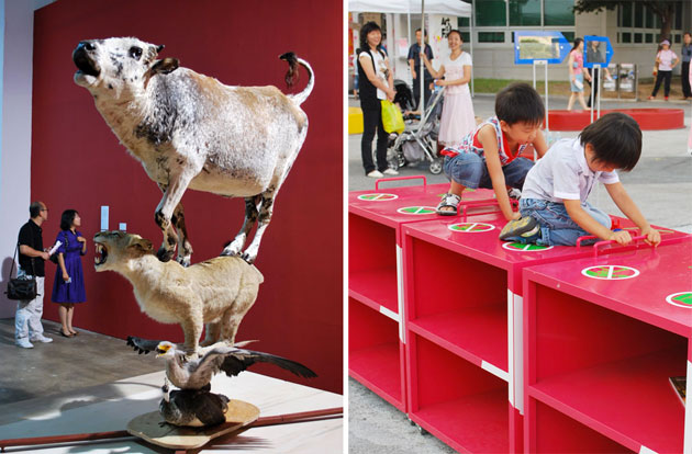 Side by side images from the Biennale exhibition at Gwangju. On the left is a taxidermy statue of a cow on top of a lioness, on top of an eagle, with a peafowl at the bottom, against a red wall. To the right, two children playing on a red block shelf, with adults watching behind.