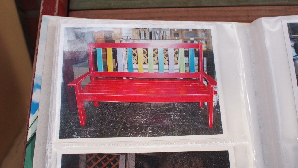 Hongdae furniture street catalogue, a picture showing a red bench with multicolored back slats, in a plastic folder.