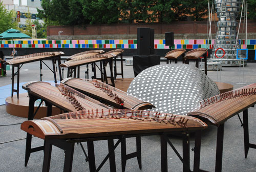 A gayageum, traditional Korean musical instrument. A large wooden contraption with strings to be played like a zither.