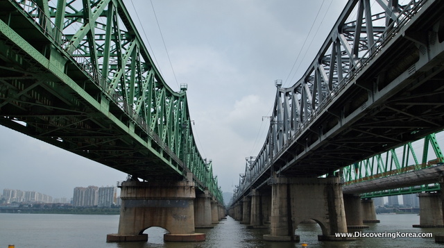 A view between two Hangang river bridges side by side towards the city, in cloudy weather.