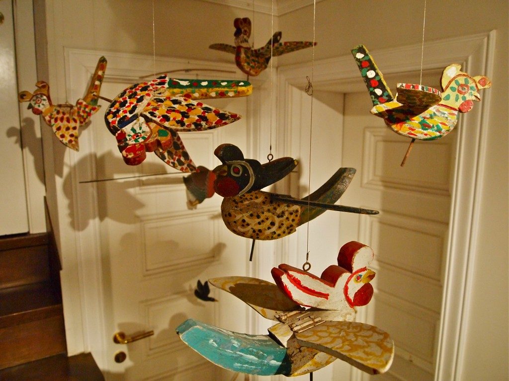 Wooden bird carvings, with movable wings hanging from the ceiling at Musee Shuim.