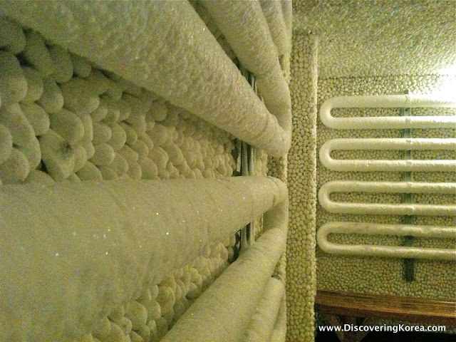 The ice room at Hongdae spa, showing pipes with ice attached to them, close up.