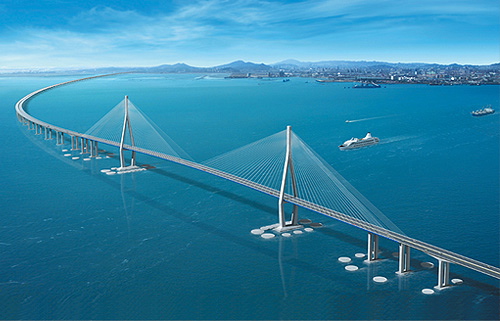 Aerial view of Incheon bridge spanning deep blue sea, with boats in the background.