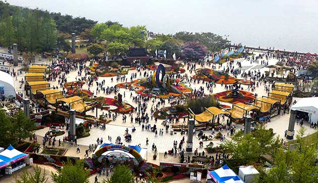 View of the international horticulture Goyang in Korea, a show ground with crowds looking at various displays of flowers and landscaping.