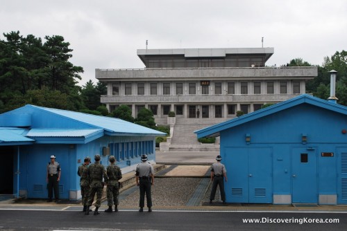 Two blue buildings flank a larger building in the Joint Security Area of the DMZ.