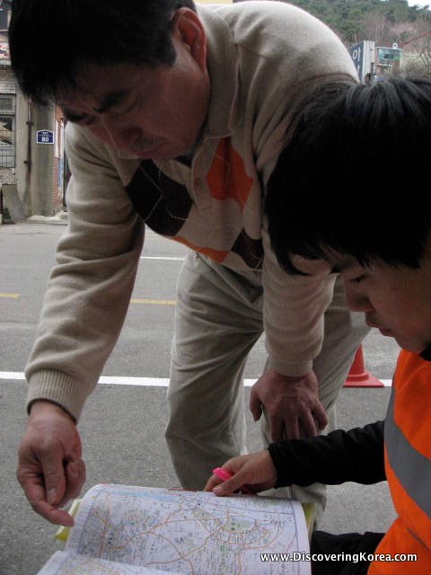 Close up of two people looking at a map.