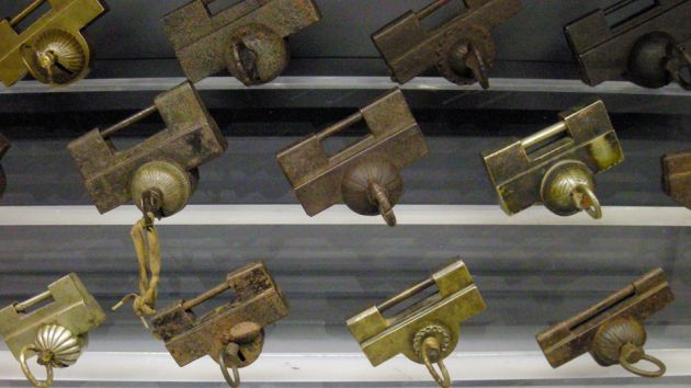 A collection of rectangular shaped padlocks, from the Lock museum in Seoul. Showing different designs in bronze.