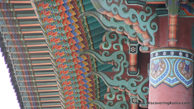 Close up of the eaves of the roof at Bosingak belfry, showing the intricate fine detail of the carving and colorful painting.