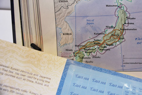 Close up of a map of Korea with a book in the foreground.
